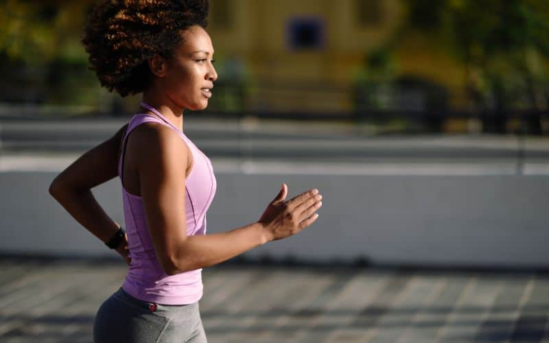 collagen-woman-afro-hairstyle-running-outdoors-min